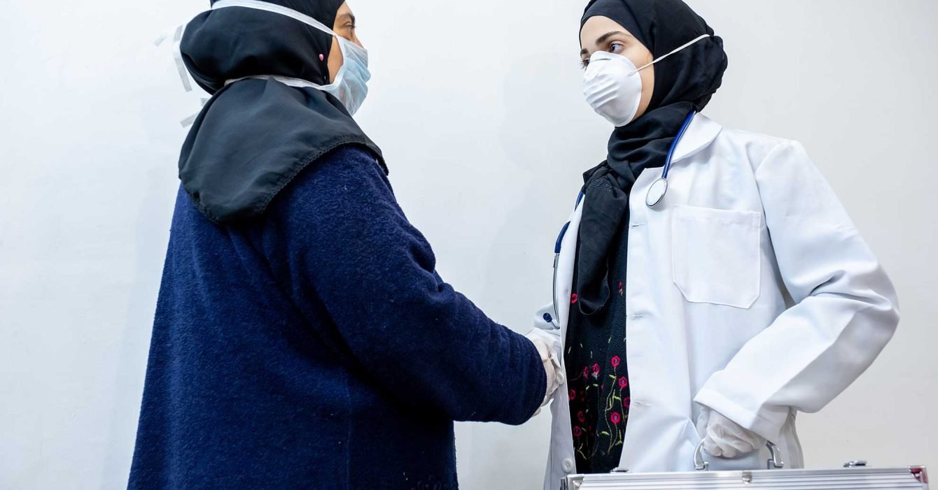 aarbic-muslim-doctor-daughter-shaking-hands-with-her-mother aarbic-muslim-doctor-daughter-shaking-hands-with-her-mother